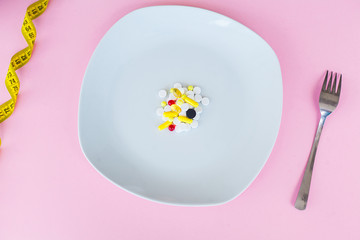 Close up of pills. Dietary supplements. Variety pills. Vitamin capsules on pink background