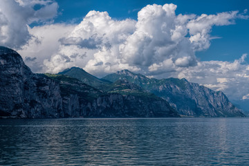 View of Lake Garda and mountains on a cloudy day.