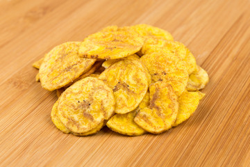 Pile of crunchy sliced dehydrated plaintain fruit chips