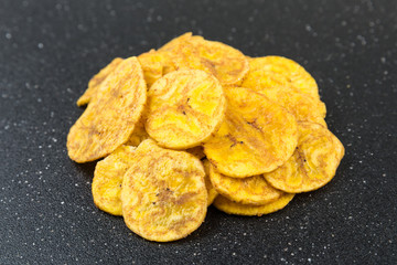 Pile of crunchy sliced dehydrated plaintain fruit chips