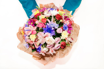 bouquet with different colors in the hands of a man