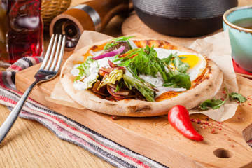 Female eat Eggs Benedict on toasted muffins with ham and sauce