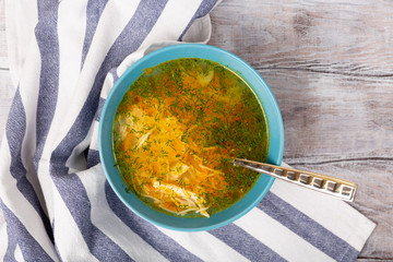 Bowl of fresh homemade soup broth to cure flu, illness, sick. on white background top view. Flat lay.
