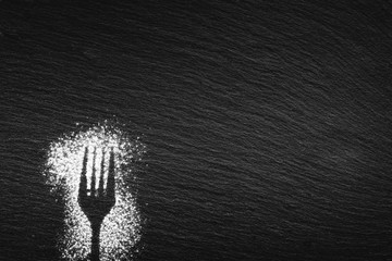 Silhouette of a fork drawn with white flour