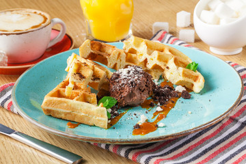 Wafers with a strawberry, cream and mint, a tasty dessert, breakfast in cafe