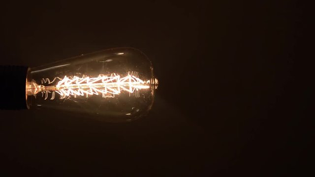 Lamp with Christmas spiral lights up on a dark background