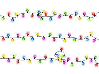 Christmas glowing lights on white background. Garlands with colored bulbs. Xmas holidays. Christmas greeting card design element. New year,winter.