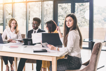 from the top view.business team discussing a problem with a business. Four international young business people sitting at the table