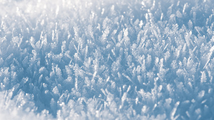 Macro look of snow crystals, snowflakes. Winter background, banner 16x9 format