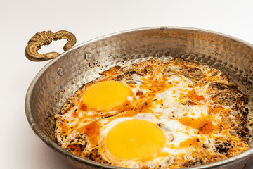 eggs with spice in copper pan