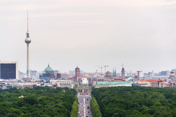 Berlin summer skyline aerial view of  Brandenburger Tor - Brandeburg gate and television tower Fernsehturm with cars passing crossroad under Victory Column in Tiergarten, Berlin, Germany © josefkubes