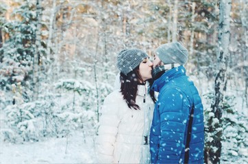 happy couple in love in winter forest