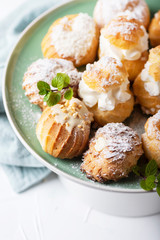 Delicious profiteroles with cream