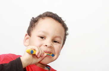 little boy brushing his teeth with tooth brush