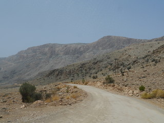 winding road on the way to the mountains of Jebel Shams on a sunny summer day, Oman, Middle East