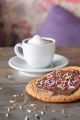 Chocolate sugar cookie with fresh cream macchiato on rustic wood