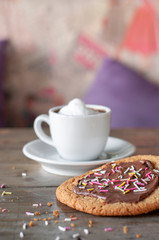 Chocolate sugar cookie with fresh cream macchiato on rustic wood