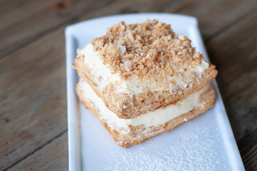 Mille-feuille is known vanilla or custard slice on white plate