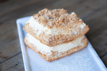 Mille-feuille is known vanilla or custard slice on white plate