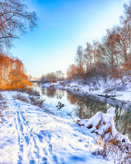 Winter landscape by a river in the sunset.