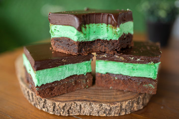 Mint brownies on wood with green background