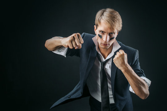 A Young Man In A Business Suit Rolled Up His Sleeves And Boxing. Aggressive Business, Concept. Businessman