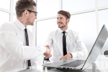 Businessmen wearing suits shaking hands