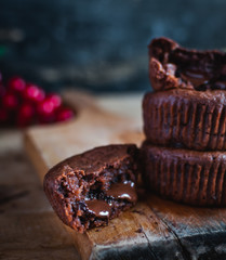 Close-up of homemade chocolate muffins on rustic cutting board