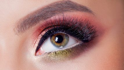 Obraz premium Amazing Bright eye makeup in luxurious scarlet shades. Pink and blue color, colored eyeshadow