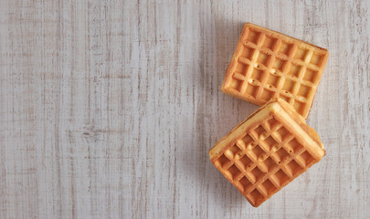 Top view of sweet fresh Viennese waffles. isolated on a wooden table. Copy space European for breakfast.