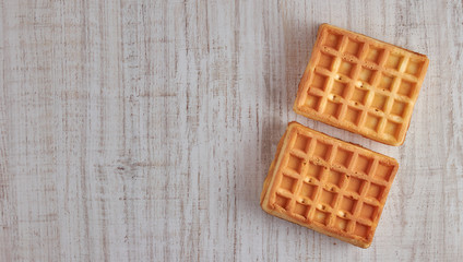 Top view of sweet fresh Viennese waffles. isolated on a wooden table. Copy space European for breakfast.