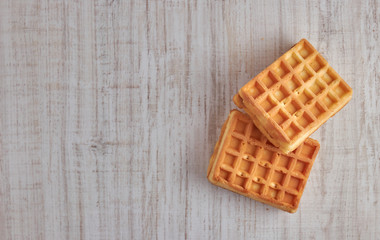 Top view of sweet fresh Viennese waffles. isolated on a wooden table. Copy space European for breakfast.