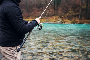 Fisherman holding fishing rod