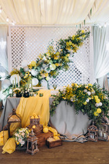 Wedding table serving. Wedding banquet. Wedding presidium for the newlyweds. Beautiful decor of flowers, lemons and candles