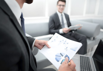 close up.the businessman analyzes the business document