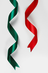 Red and green satin ribbon on white background