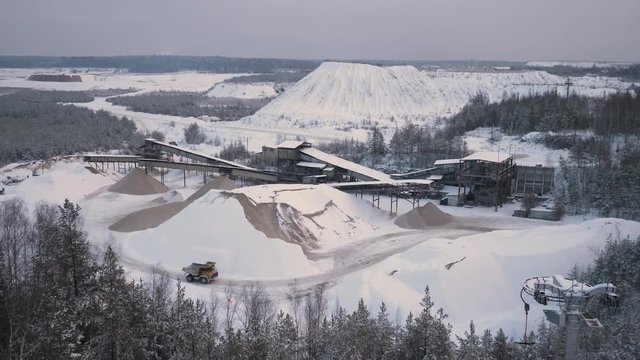Mountain quarry on which trucks drive on the background of the Northern landscape. 4K