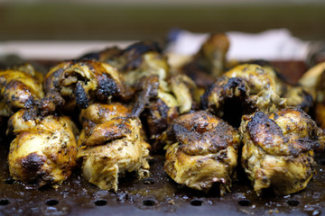 Pile of grilled barbecue chicken ready to serve on buffet counter