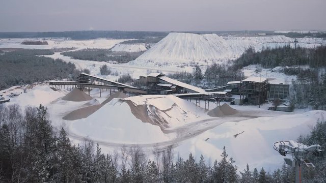 Mountain quarry on which trucks drive on the background of the Northern landscape. 4K