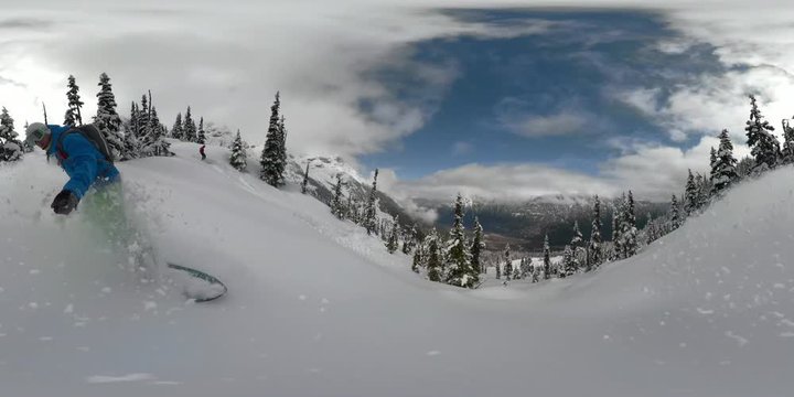 360VR: Pro snowboarder heliboarding in picturesque British Columbia speeding downhill and evading the snowy spruce trees. Athletic male tourist having fun snowboarding in the beautiful mountains.