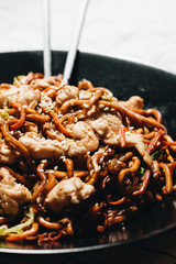 Delicious spicy noodles with meat in pot, traditional Aisan food, chopsticks
