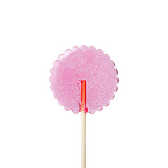 transparent pink lollipop on a wooden stick on a white background