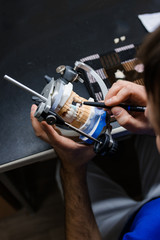 Dental technician working with articulator in dental laboratory
