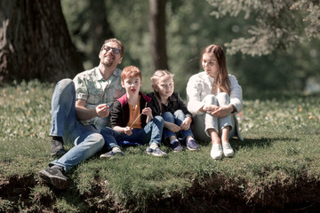 Fototapeta premium happy family resting in the Park on a summer day.