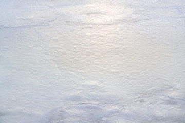 Texture of first ice on the lake in late autumn
