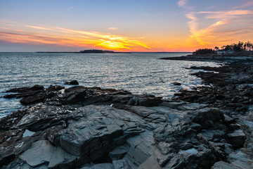 A vibrant sunset above the rocky coast of Maine. 