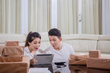 Couple with tablet sell product online