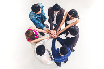 Top view of successful of group business people stack and putting their hands together at...