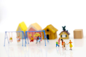 Miniature people, children and family enjoy with swing , happy family day concept.