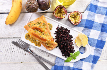 Traditional madeira dish - scabbardfish with bananas and passion fruit